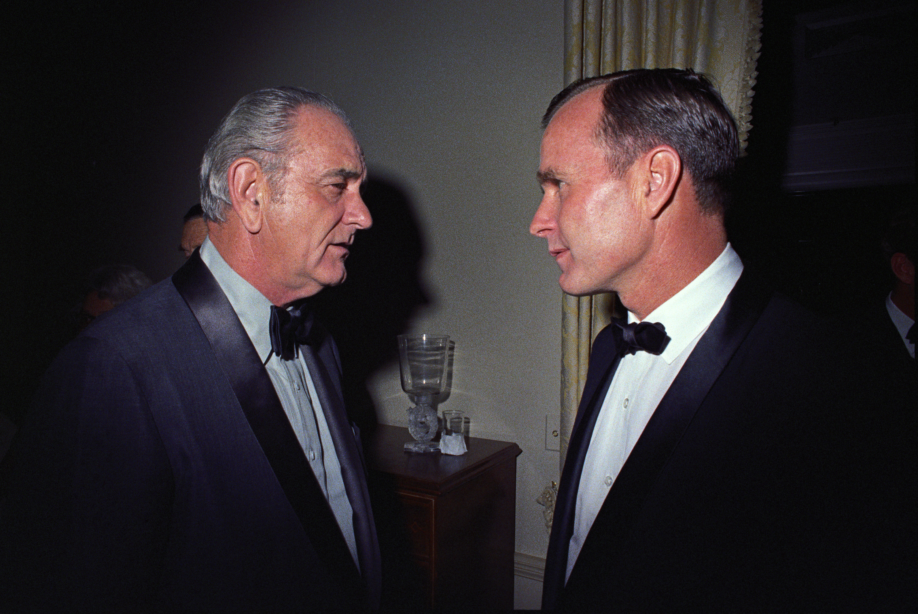 President Johnson and Congressman George H. W. Bush in tuxedos.